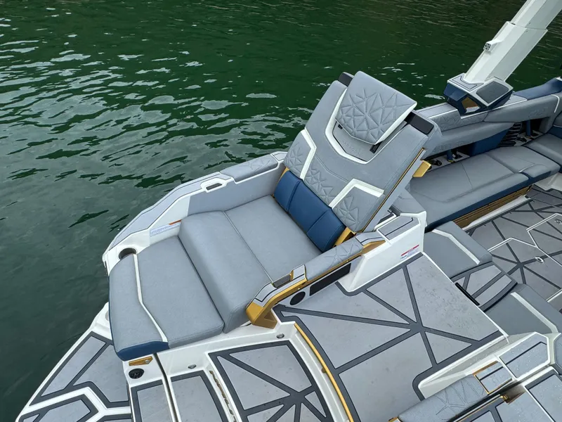 Slide: The Image of 2024 Nautique Super Air Nautique G25 Paragon boat interior with luxurious seating on water. - 17