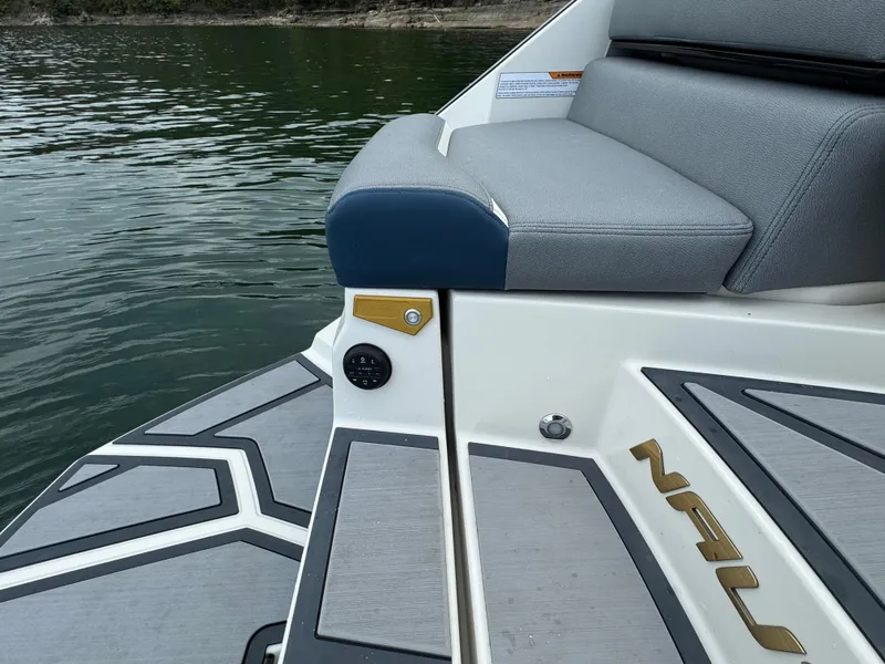 Slide: The Image of 2024 Nautique Super Air Nautique G25 Paragon boat interior with gray seating and deck details. - 21