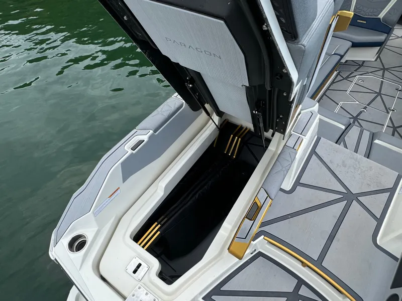 Slide: The Image of 2024 Nautique Super Air Nautique G25 Paragon storage compartment open on deck. - 22