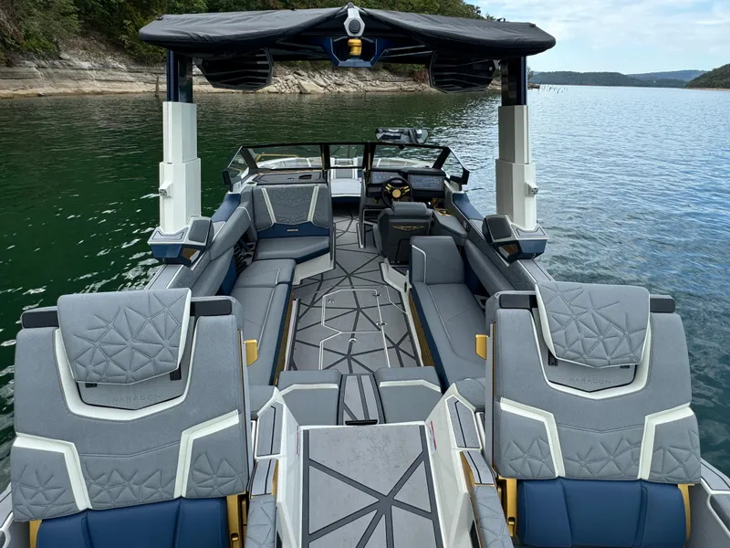Slide: The Image of 2024 Nautique Super Air Nautique G25 Paragon on a serene lake, showcasing luxurious interior. - 7