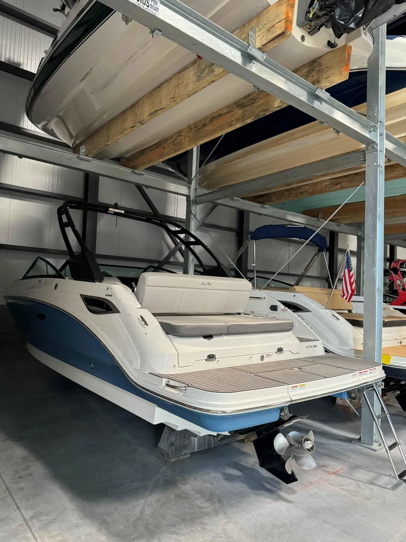 Slide: The Image of 2023 Sea Ray 250SDX boat in storage, showcasing sleek design and modern features. - 4