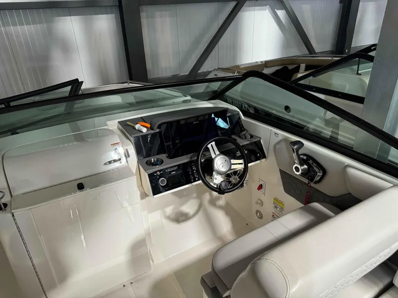 Slide: The Image of 2023 Sea Ray 250SDX boat interior with steering wheel and dashboard controls. - 8