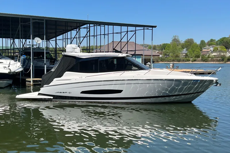 The Image of 2021 Regal 36 Grande Coupe yacht docked on a sunny day. - 0