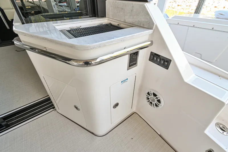 Slide: The Image of 2021 Regal 36 Grande Coupe yacht interior with modern kitchenette and sleek design. - 17