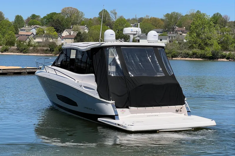 Slide: The Image of 2021 Regal 36 Grande Coupe boat on a serene lake. - 2