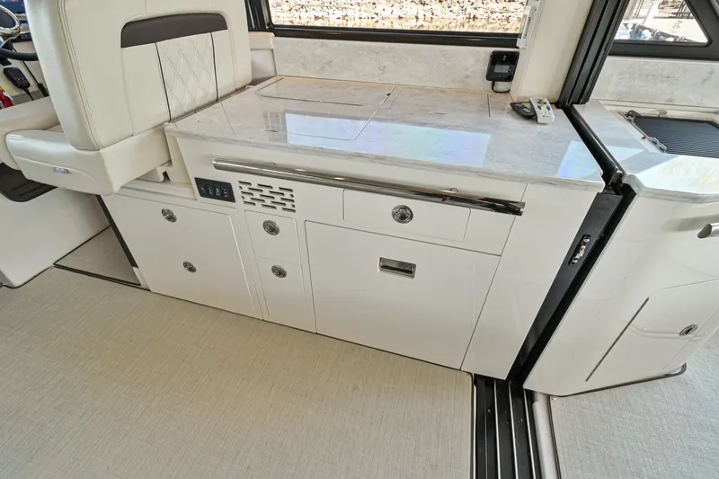 Slide: The Image of Interior of 2021 Regal 36 Grande Coupe yacht with sleek cabinetry and seating. - 23