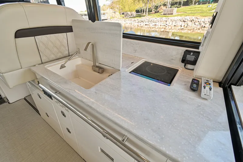Slide: The Image of Luxurious kitchen area in 2021 Regal 36 Grande Coupe yacht with sink and stove. - 25