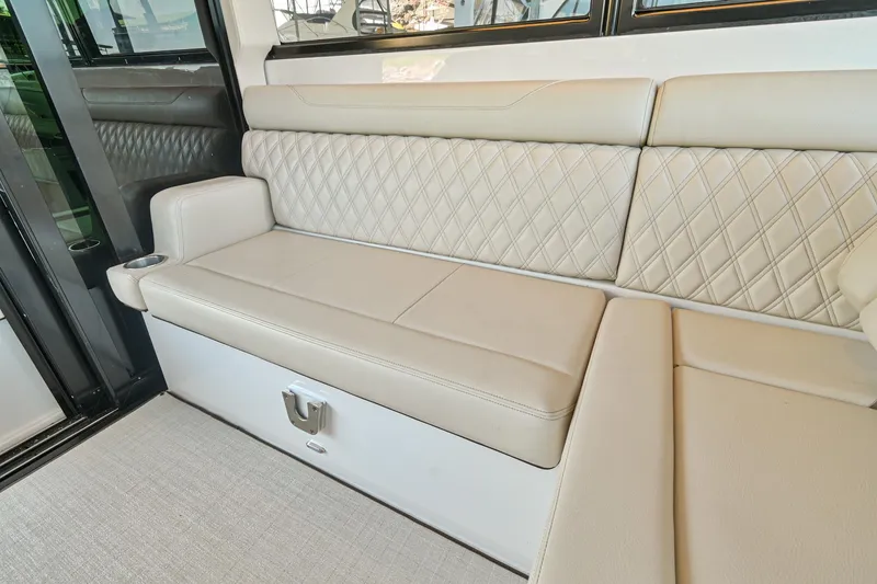 Slide: The Image of Luxurious beige seating in 2021 Regal 36 Grande Coupe yacht interior. - 28