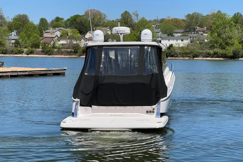 Slide: The Image of 2021 Regal 36 Grande Coupe boat on a serene lake. - 3