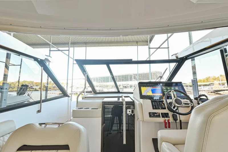 Slide: The Image of Interior view of 2021 Regal 36 Grande Coupe yacht cockpit with modern controls. - 31