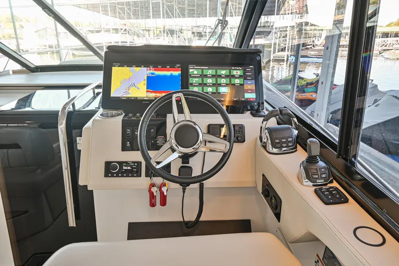 Slide: The Image of 2021 Regal 36 Grande Coupe helm with advanced navigation displays and controls. - 35