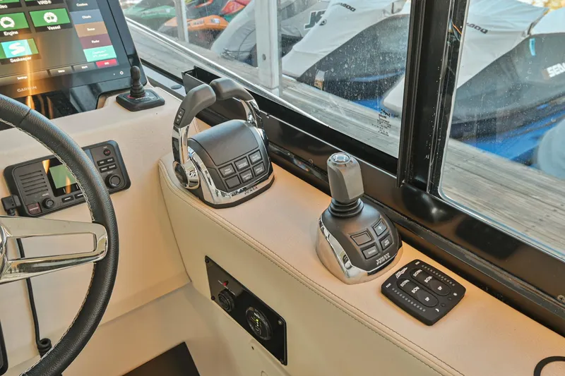 Slide: The Image of Control panel of 2021 Regal 36 Grande Coupe boat with joystick and throttle. - 36
