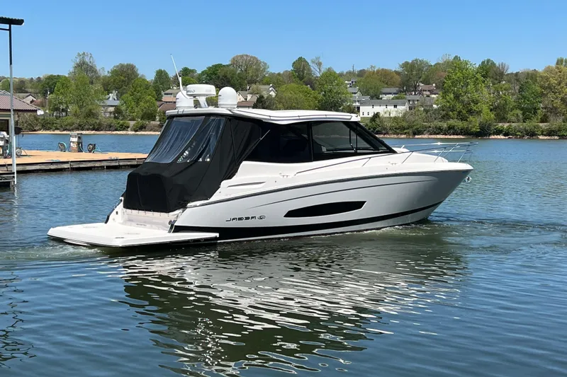 Slide: The Image of 2021 Regal 36 Grande Coupe boat on a serene lake. - 4