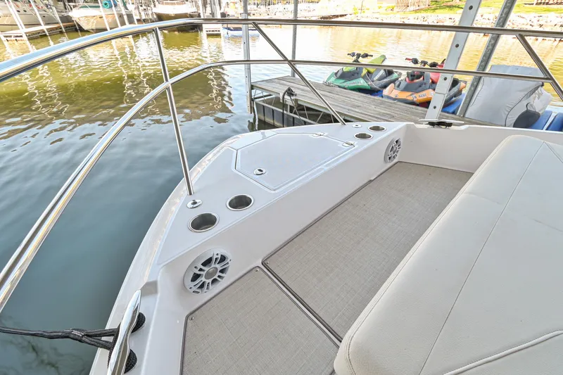 Slide: The Image of 2021 Regal 36 Grande Coupe boat interior with seating and water view. - 47