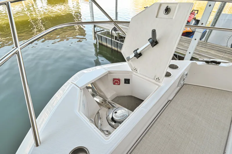 Slide: The Image of 2021 Regal 36 Grande Coupe anchor compartment with open hatch, dockside view. - 48