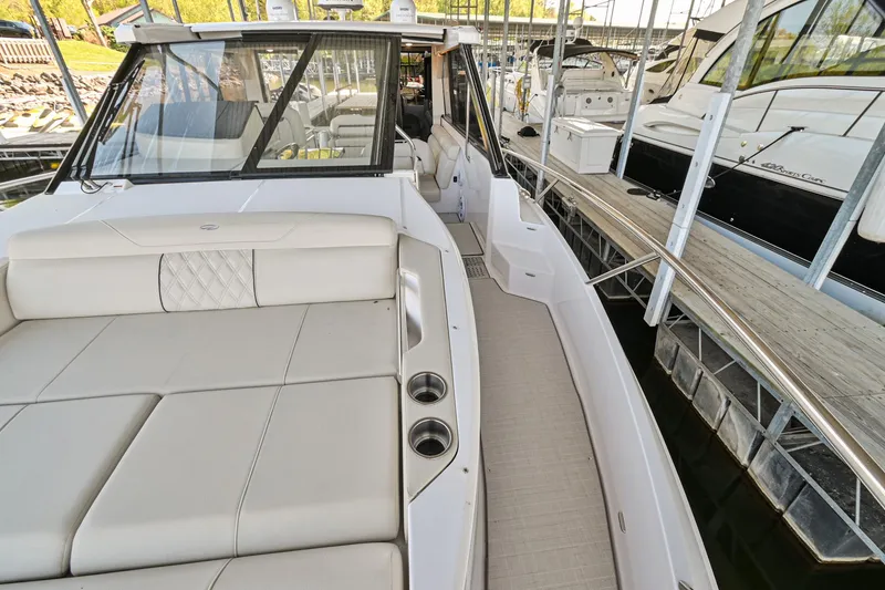 Slide: The Image of 2021 Regal 36 Grande Coupe luxury yacht with spacious deck and seating area. - 49