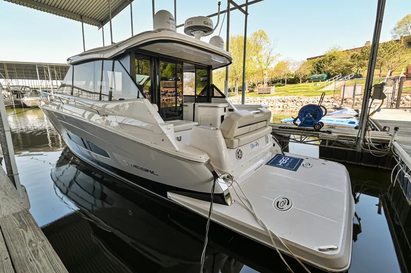Slide: The Image of 2021 Regal 36 Grande Coupe yacht docked in a marina. - 6