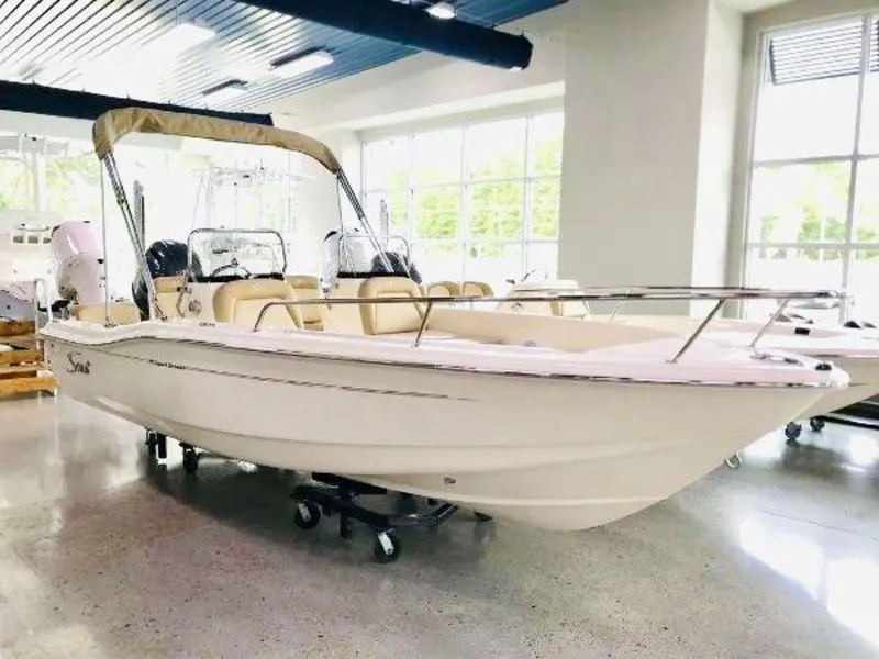 The Image of 2025 Scout 175 Sport Dorado boat displayed in a showroom. - 1