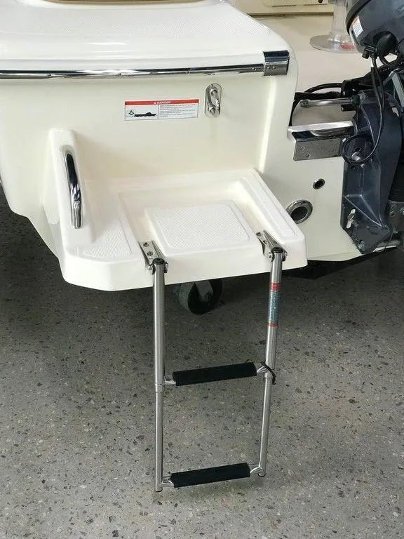 Slide: The Image of 2025 Scout 175 Sport Dorado boat with foldable swim ladder and outboard motor. - 11