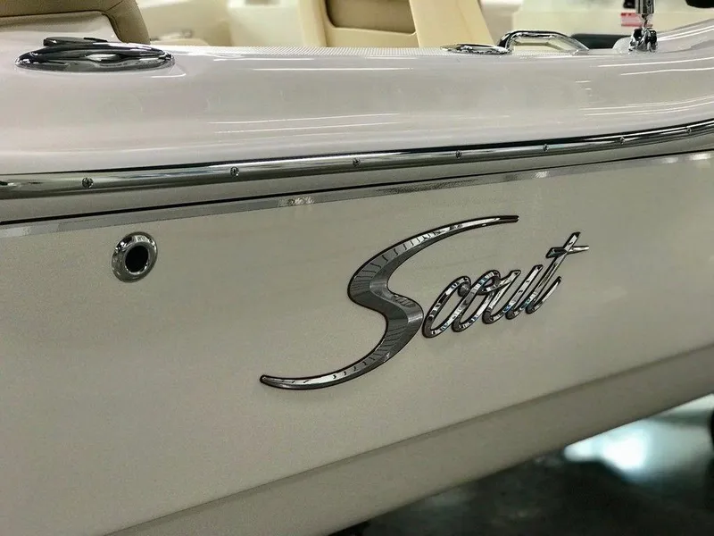 Slide: The Image of 2025 Scout 175 Sport Dorado boat, sleek design with chrome logo detail. - 13