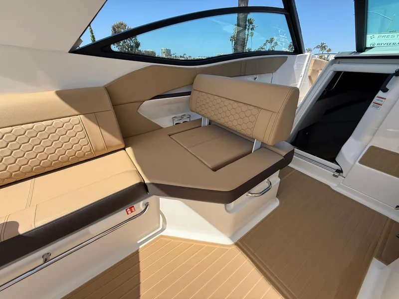 Slide: The Image of 2025 Sea Ray Sundancer 320 OB interior with tan seating and modern design. - 12