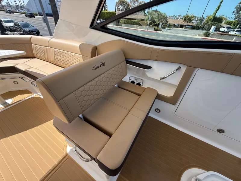 Slide: The Image of 2025 Sea Ray Sundancer 320 OB interior with tan seating and modern design. - 13
