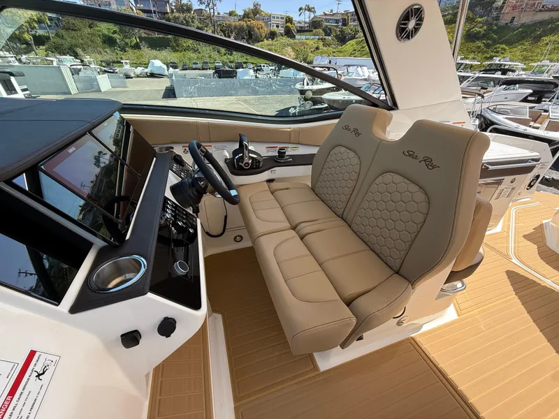 Slide: The Image of 2025 Sea Ray Sundancer 320 OB cockpit with luxurious seating and modern controls. - 14