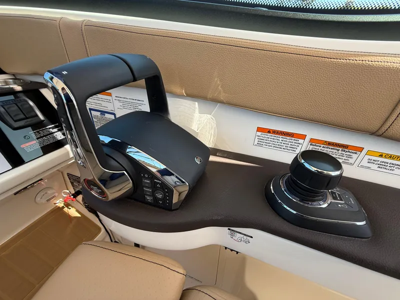 Slide: The Image of 2025 Sea Ray Sundancer 320 OB helm controls with joystick and throttle. - 15