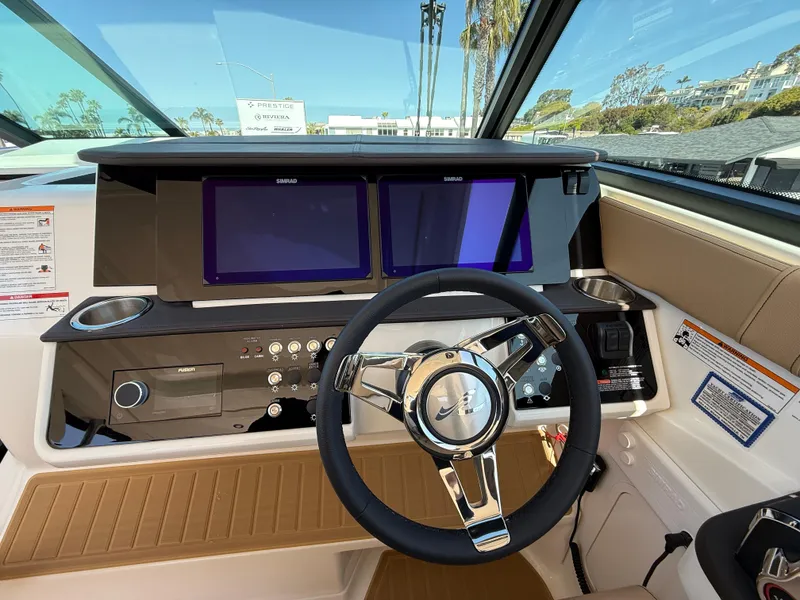 Slide: The Image of 2025 Sea Ray Sundancer 320 OB helm with dual screens and modern steering wheel. - 16