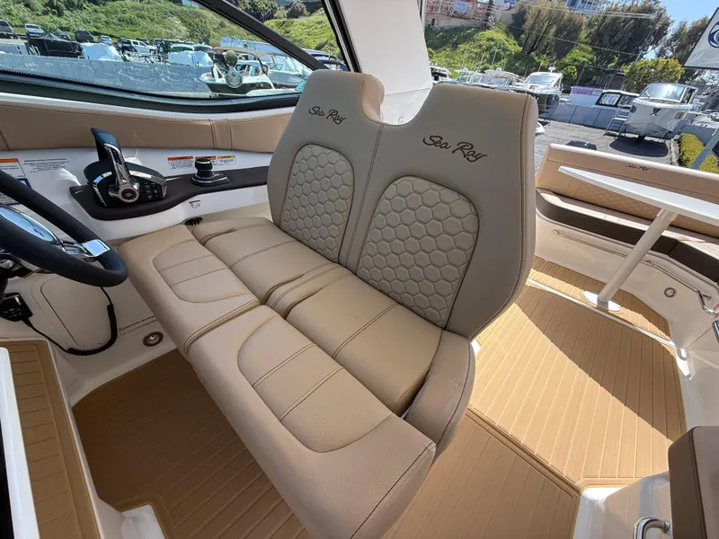 Slide: The Image of Luxurious interior of 2025 Sea Ray Sundancer 320 OB with beige seating and modern controls. - 17