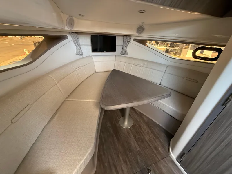 Slide: The Image of 2025 Sea Ray Sundancer 320 OB cabin with elegant seating and modern table. - 19