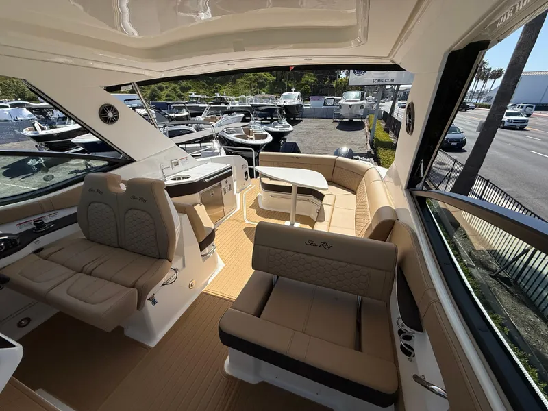 Slide: The Image of 2025 Sea Ray Sundancer 320 OB interior with luxurious seating and modern design. - 23