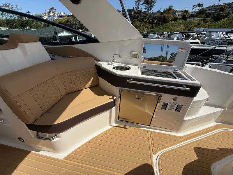 Slide: The Image of Luxurious interior of 2025 Sea Ray Sundancer 320 OB with seating and kitchenette. - 8