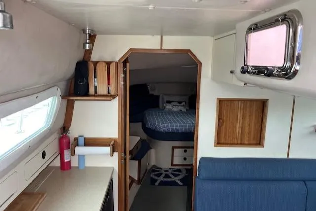 Slide: The Image of Interior of 2003 Albin 32 + 2 Command Bridge, featuring cozy cabin and nautical decor. - 14