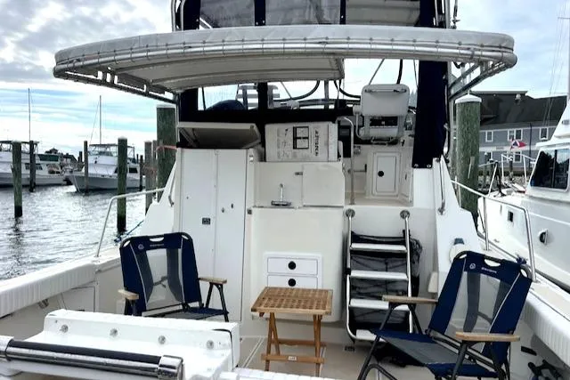 Slide: The Image of 2003 Albin 32 + 2 Command Bridge boat with seating area in a marina. - 2