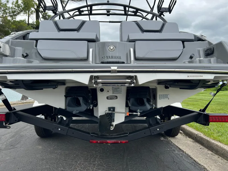 Slide: The Image of 2025 Yamaha Boats 255XE rear view, showcasing dual engines and sleek design on a trailer. - 6