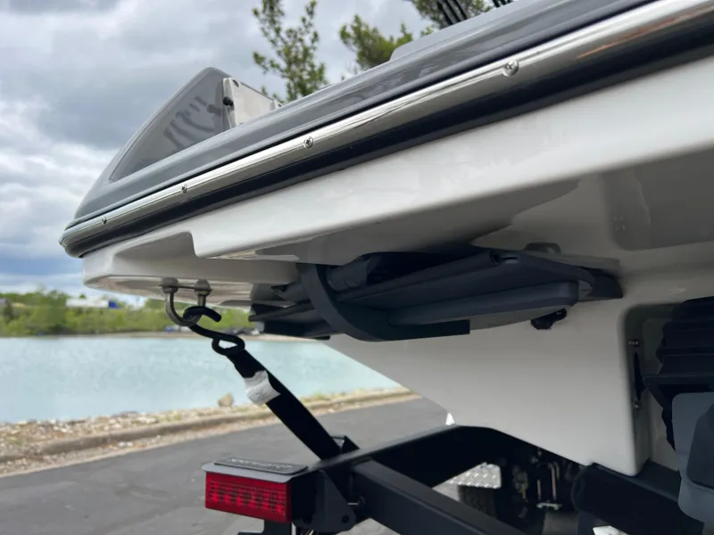 Slide: The Image of 2025 Yamaha Boats 255XE rear view, showcasing sleek design near a waterfront. - 7