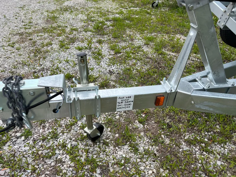 Slide: The Image of Trailer hitch for 2025 Yamaha Boats 255XE on gravel and grass surface. - 8