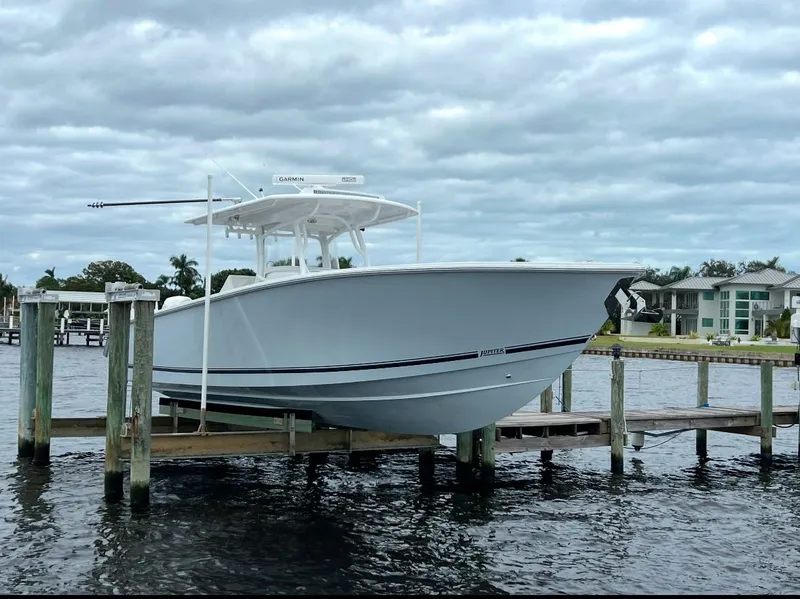 Slide: The Image of 2021 Jupiter 38 HFS boat docked on a lift by waterfront homes. - 19