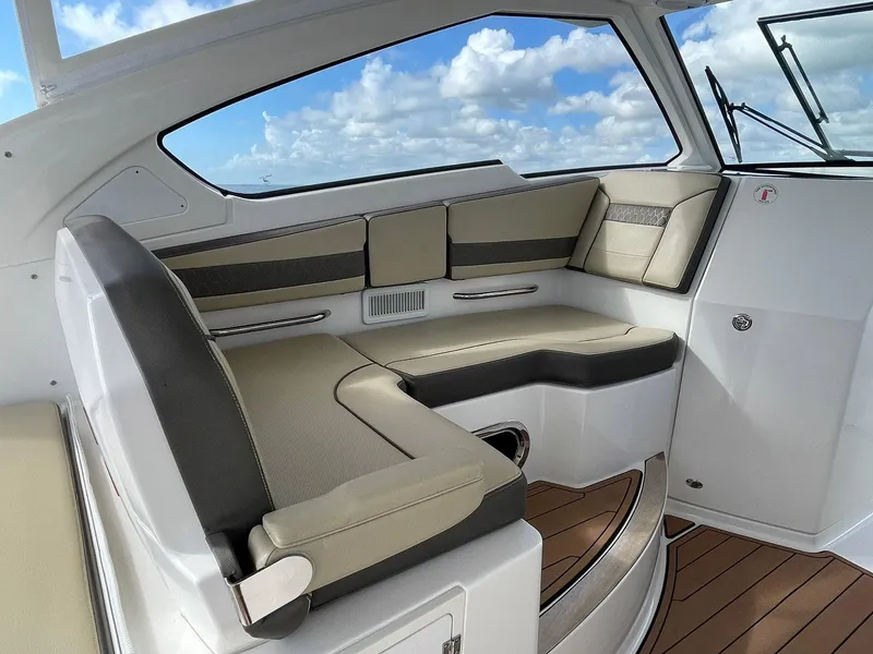 Slide: The Image of 2019 Pursuit 365 Dual Console interior with cushioned seating and wood flooring. - 16