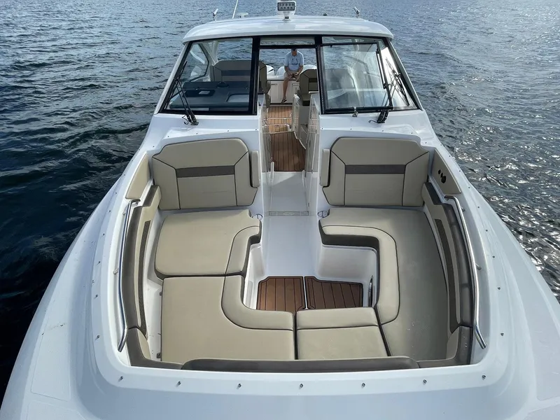 Slide: The Image of 2019 Pursuit 365 Dual Console boat with spacious seating on calm water. - 21