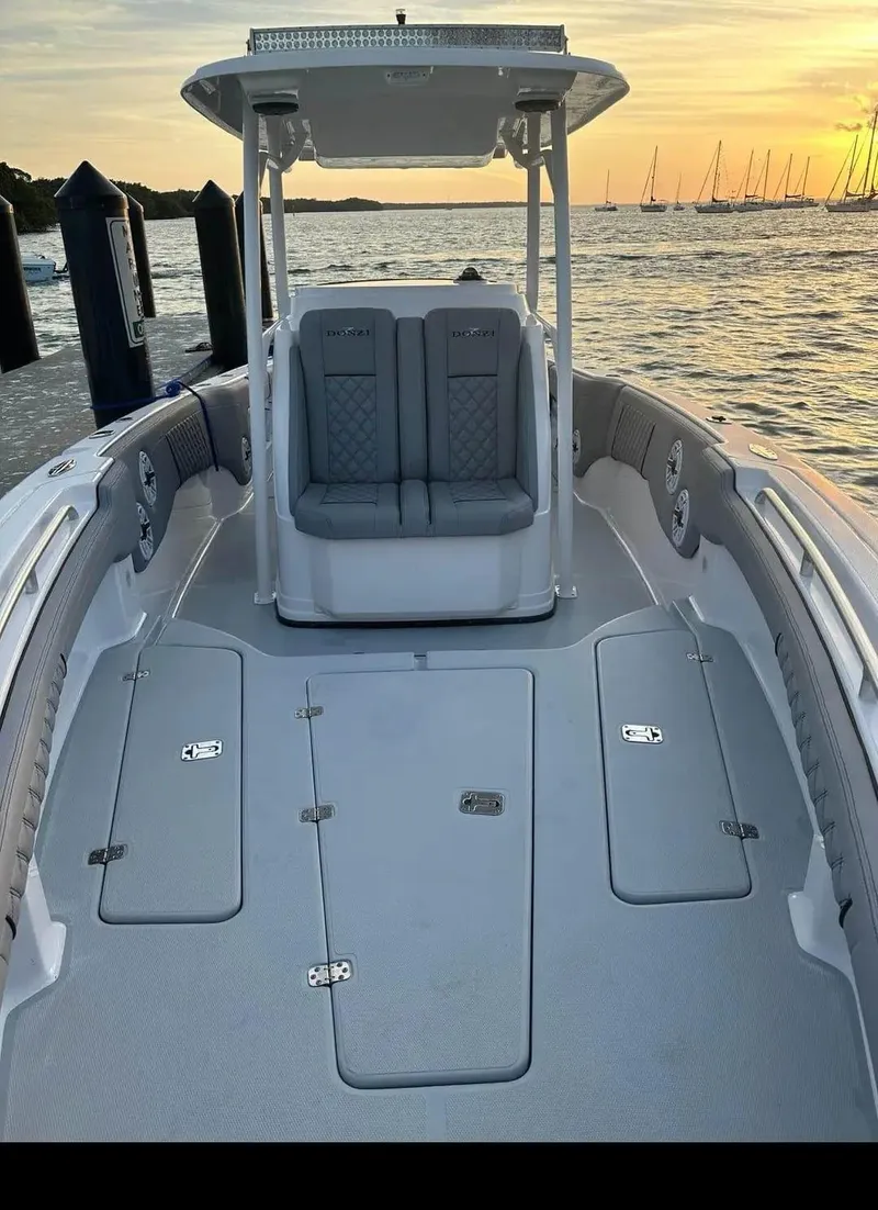 Slide: The Image of 2007 Donzi 35 ZF Open boat at sunset, docked by the water. - 13