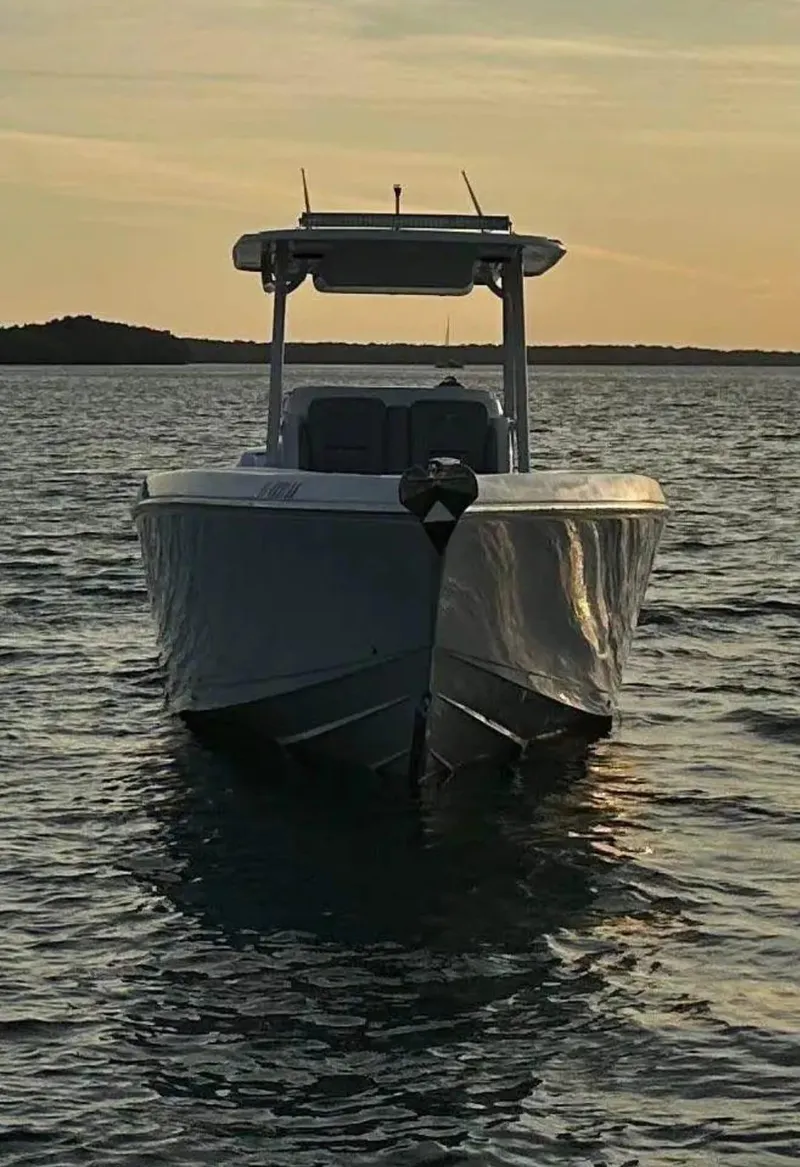 Slide: The Image of 2007 Donzi 35 ZF Open boat on calm water at sunset. - 14