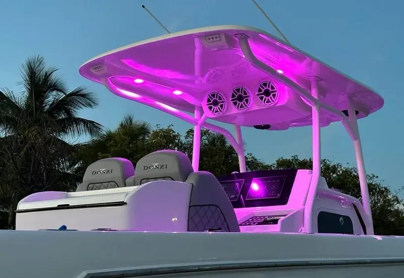 Slide: The Image of 2007 Donzi 35 ZF Open boat with vibrant purple LED lights at dusk. - 15