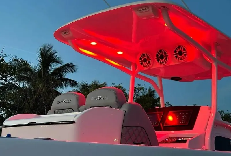 Slide: The Image of 2007 Donzi 35 ZF Open boat with red interior lighting at dusk. - 16