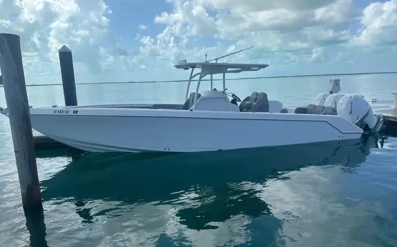 Slide: The Image of 2007 Donzi 35 ZF Open boat on calm water under a cloudy sky. - 17