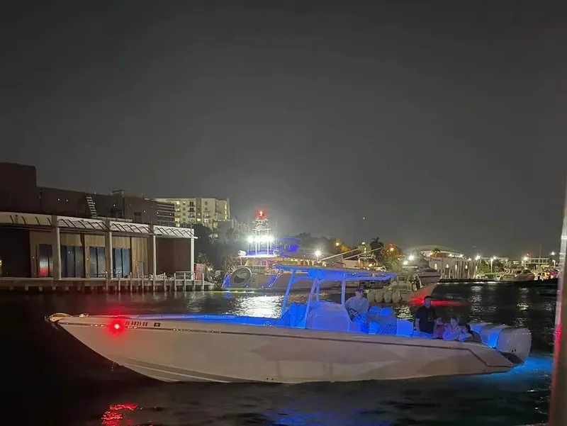 Slide: The Image of 2007 Donzi 35 ZF Open boat illuminated at night near a marina. - 18