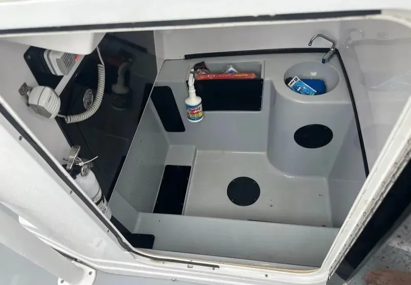 Slide: The Image of Interior of 2007 Donzi 35 ZF Open boat, featuring compact storage and sink area. - 3