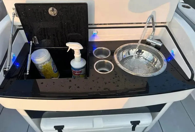 Slide: The Image of 2007 Donzi 35 ZF Open boat sink with faucet and storage compartments. - 4