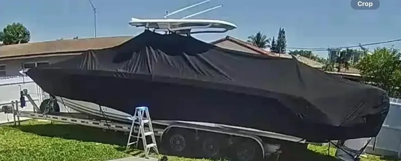 Slide: The Image of 2007 Donzi 35 ZF Open boat covered on trailer in residential yard. - 7